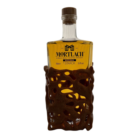 Mortlach x Starck single malt whisky bottle with distinctive label and amber liquid inside, showcasing premium Scotch whisky craftsmanship
