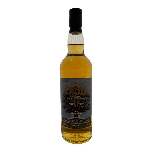 James Eadie Tamnavulin 11-year-old single malt whisky bottle on a wooden surface with a blurred background.